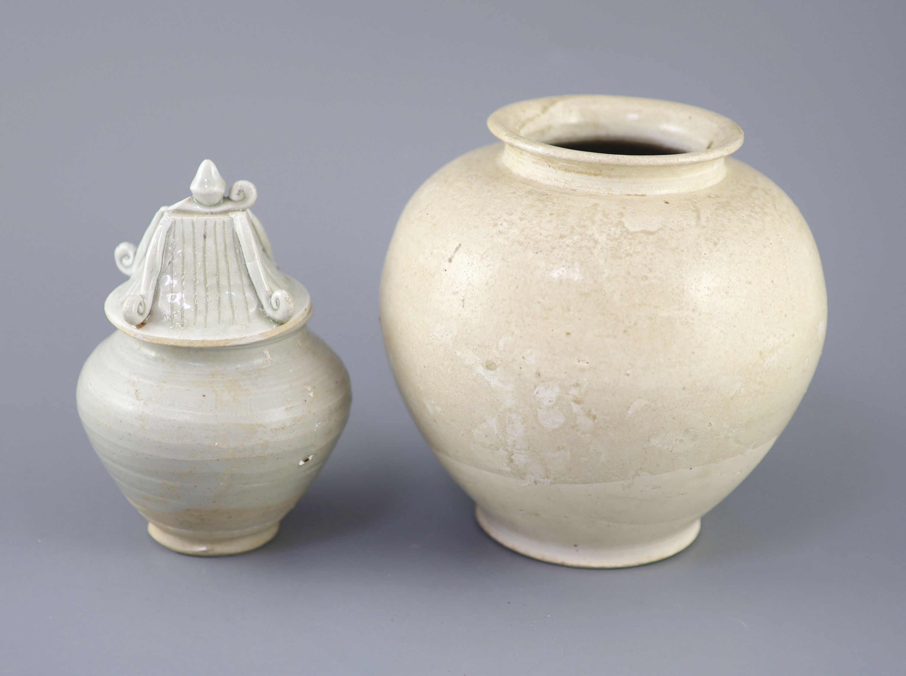 A Chinese cream glazed ovoid jar, Tang dynasty and a Ding type jar and cover, Yuan dynasty,